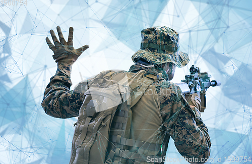 Image of soldier in action giving comands to team by hand sign