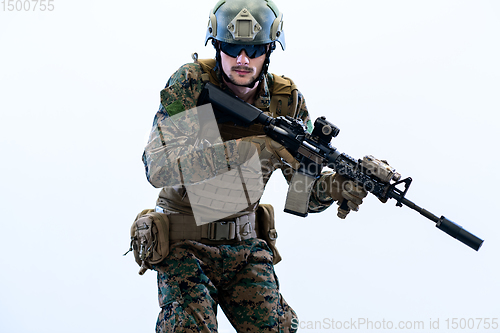 Image of soldier in action aiming laseer sight optics