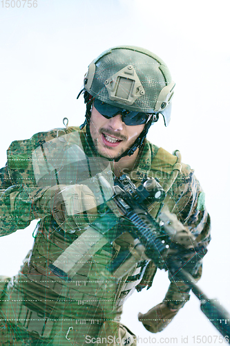 Image of soldier in action aiming laseer sight optics