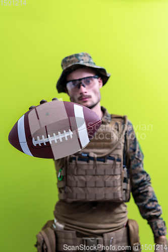 Image of solder holding american football ball