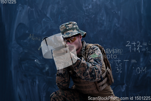 Image of soldier in action aiming laseer sight optics