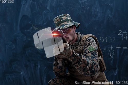 Image of soldier in action aiming laseer sight optics