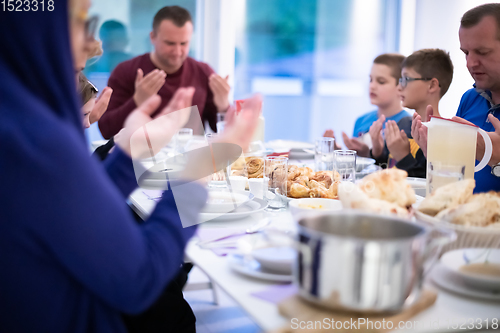 Image of Eid Mubarak  Islamic family praying before halal Iftar dinner