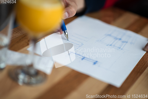 Image of The hand of the designer with a pen sketching his idea