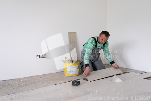 Image of worker installing the ceramic wood effect tiles on the floor