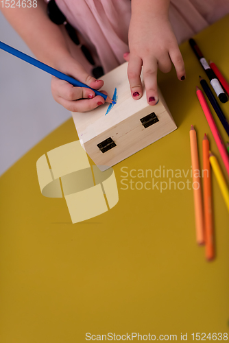 Image of little girl painting jewelry box