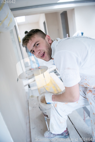 Image of construction worker plastering on gypsum walls