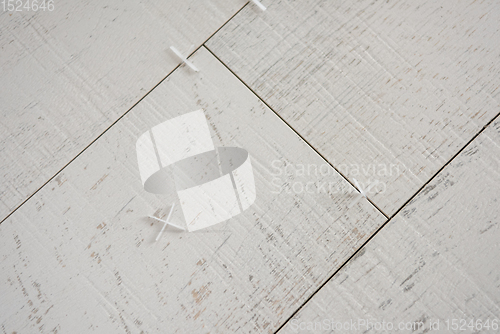 Image of Ceramic wood effect tiles and tools for tiler on the floor