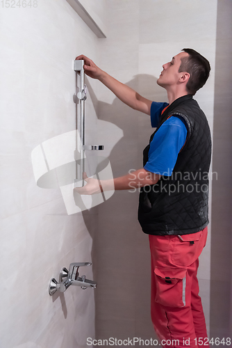 Image of professional plumber working in a bathroom