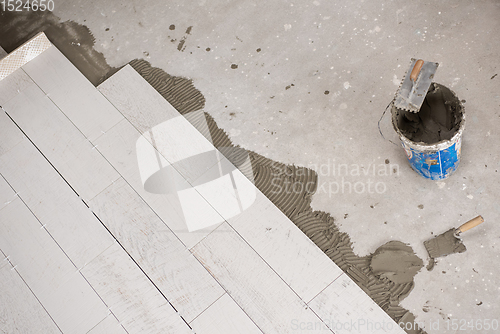 Image of Ceramic wood effect tiles and tools for tiler on the floor