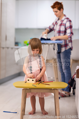 Image of mother and daughter spending time together at home