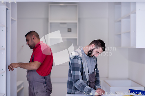 Image of workers installing a new kitchen