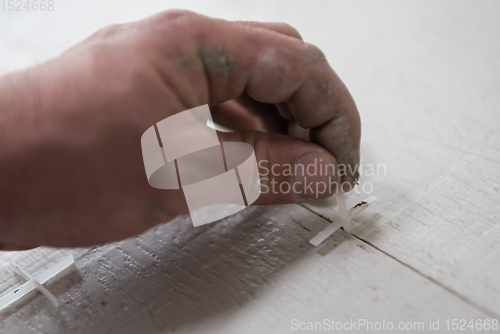 Image of worker installing the ceramic wood effect tiles on the floor