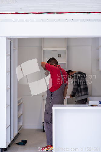 Image of workers installing a new kitchen