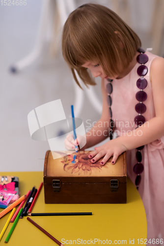 Image of little girl painting jewelry box