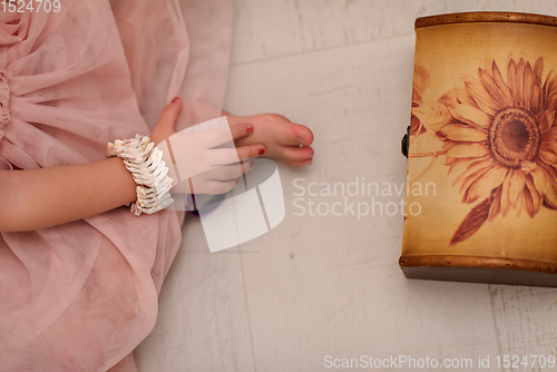 Image of little girl enjoying while playing with mother\'s jewelry