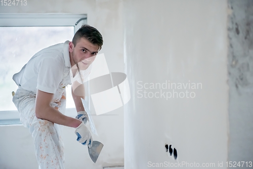 Image of construction worker plastering on gypsum walls