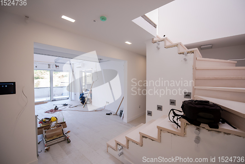 Image of carpenters installing glass door with a wooden frame