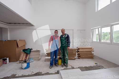 Image of portrait of Workers and builders with dirty uniform in apartment