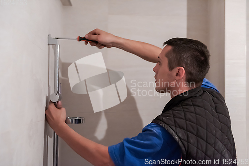 Image of professional plumber working in a bathroom