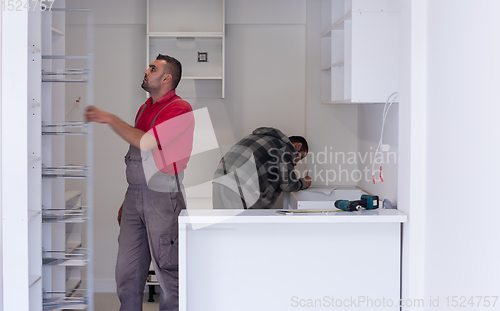 Image of workers installing a new kitchen