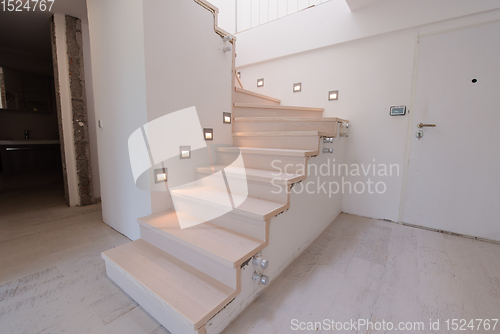 Image of stylish interior with wooden stairs