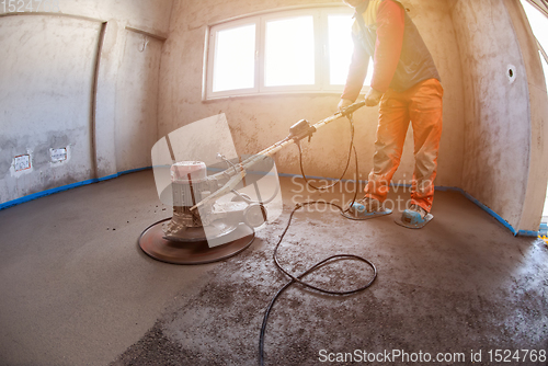 Image of worker performing and polishing sand and cement screed floor