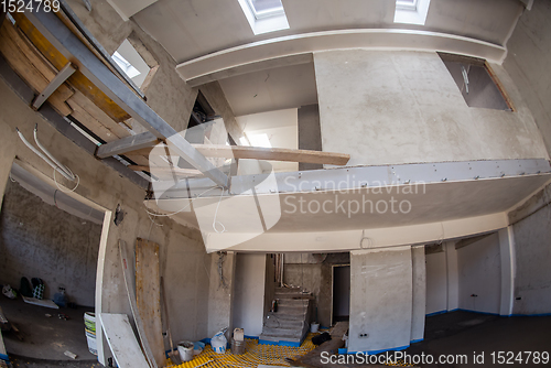 Image of yellow underfloor heating installation with white pipes