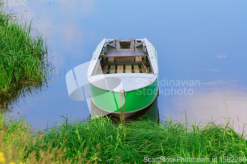 Image of Metal rowboat on the lake 