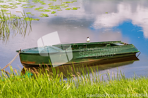 Image of Metal rowboat on the lake 