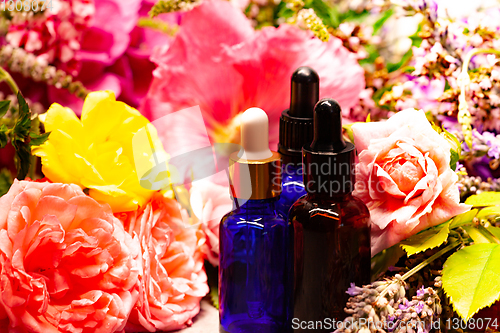 Image of flowers and bottles of essential oils for aromatherapy