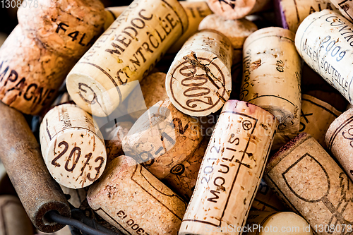 Image of old cork stoppers of French wines in a wire basket