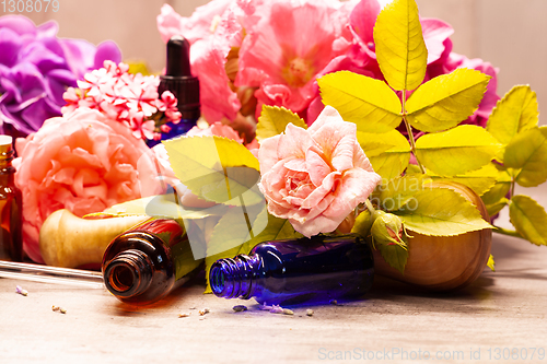 Image of flowers and bottles of essential oils for aromatherapy