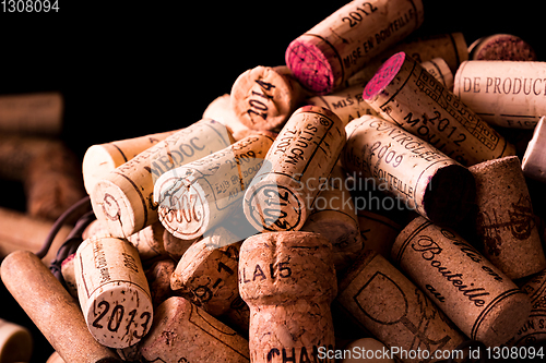 Image of old cork stoppers of French wines in a wire basket