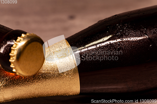 Image of a bottle of blonde beer and a bottle of amber beer lying down