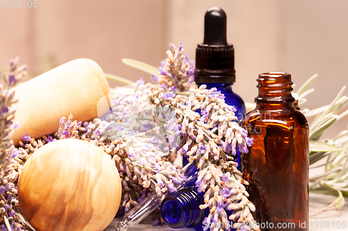 Image of lavender mortar and pestle and bottles of essential oils for aro