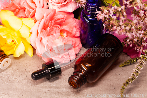 Image of flowers and bottles of essential oils for aromatherapy