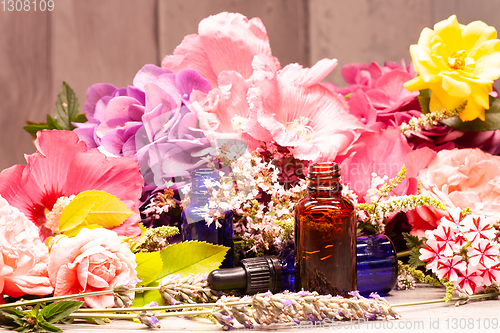 Image of flowers and bottles of essential oils for aromatherapy