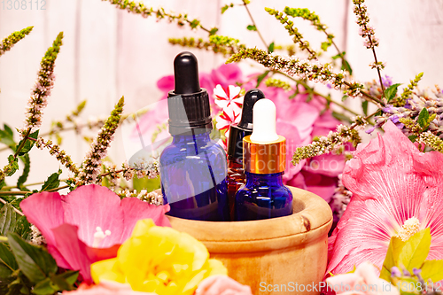 Image of flowers and bottles of essential oils for aromatherapy