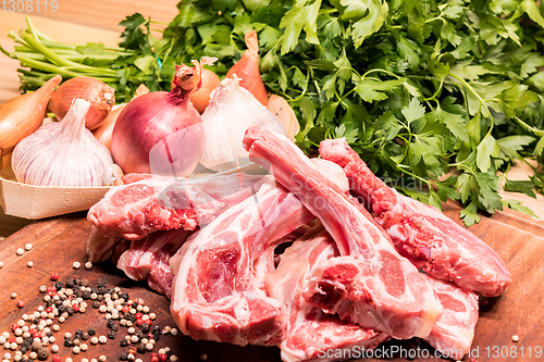 Image of raw lamb chops on a wooden board for barbecue