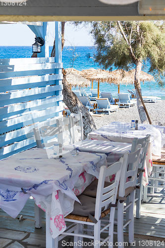 Image of restaurant terrace in front of the beach in kamari on the island