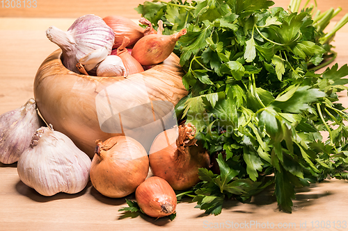 Image of garlic onion shallot parsley with pestle and olive wood mortar