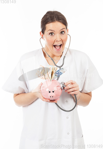 Image of happy woman doctor with piggy bank full of money