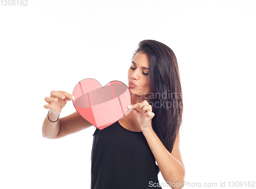 Image of beautiful happy young woman who is holding a big red heart for v