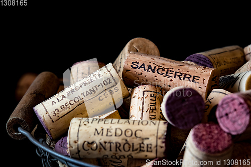 Image of old cork stoppers of French wines in a wire basket