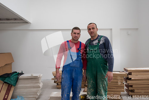 Image of portrait of Workers and builders with dirty uniform in apartment