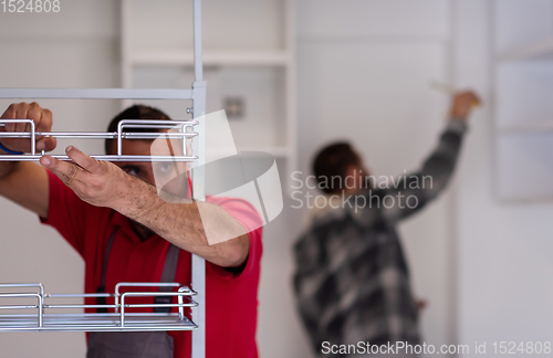 Image of workers installing a new kitchen