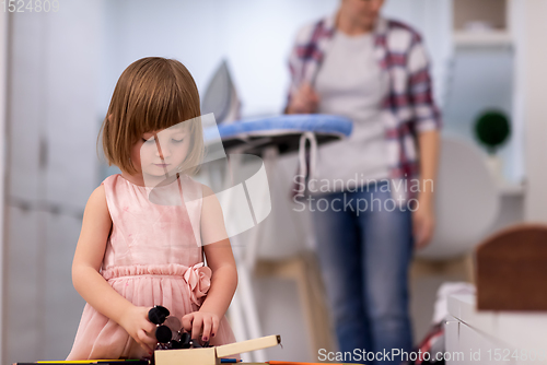 Image of mother and daughter spending time together at home