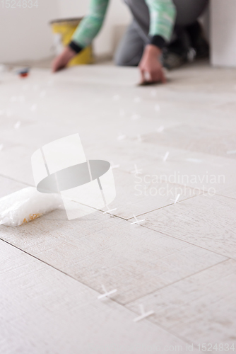 Image of worker installing the ceramic wood effect tiles on the floor