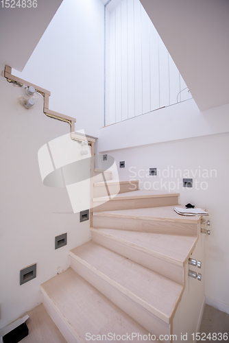 Image of stylish interior with wooden stairs